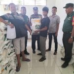 Bhabinkamtibmas Polsek Dolok, Aiptu Monang Siregar, saat mengawal jalannya penyaluran bantuan ke masyarakat