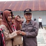 Kajari, Dr Lambok MJ Sidabutar, saat memberikan souvenir ke siswa SMAN 4 Padangsidimpuan yang berani bertanya usai kegiatan penyuluhan hukum terkait UU ITE