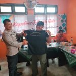 Kasat Tahti Polres Tapsel, Iptu Asjul Pane, menyerahkan kaos relawan Pilkada damai anti politik uang dalam gerakan Kapolres Jelajah Huta