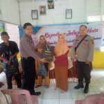 Ka SPKT Polres Tapsel, Ipda Irwan H Sarumpaet, menyerahkan souvenir ke perwakilan masyarakat di sela gerakan Kapolres Jelajah Huta