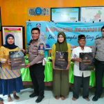 Kanit Gakkum Sat Lantas Polres Tapsel, Ipda Samuel Jefri Hutapea, saat menyerahkan souvenir ke perwakilan masyarakat di sela gerakan Kapolres Jelajah Huta