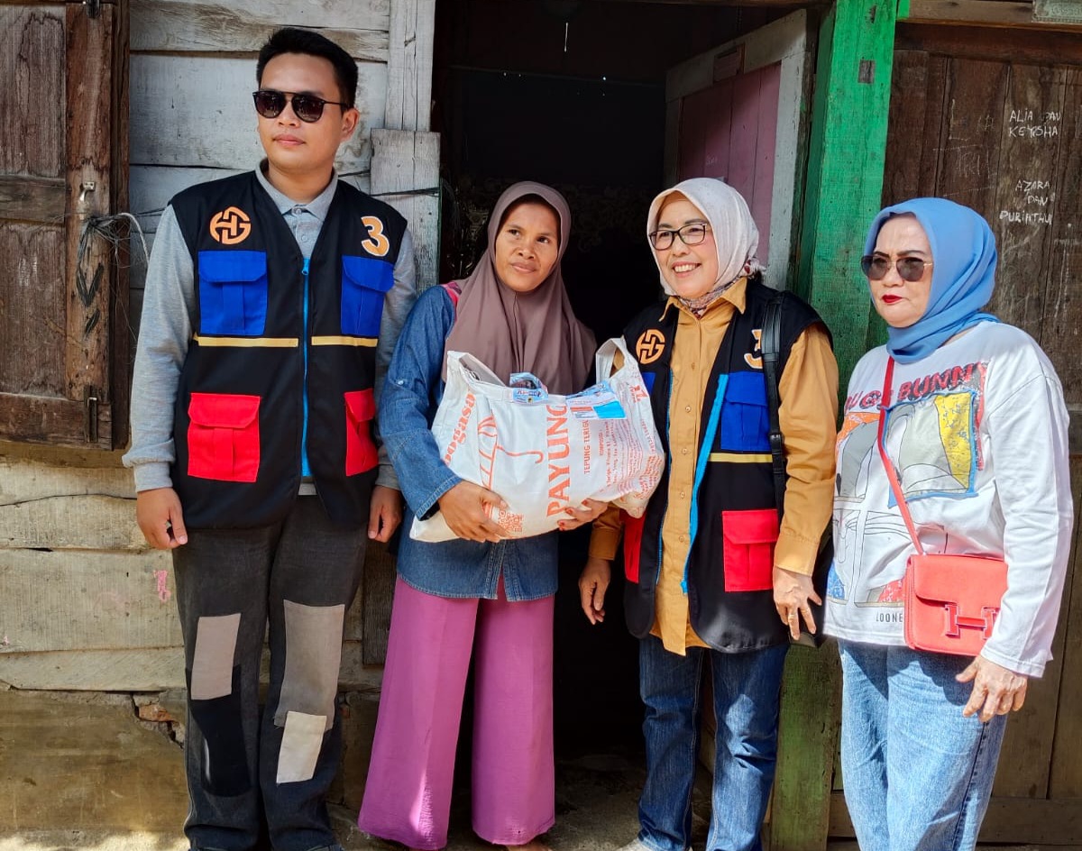 Ny Bariyah Hapendi Harahap atau karib disapa Ria, istri dari calon Wali Kota No.03, Dr Hapendi Harahap, saat menyerahkan bantuan berupa bahan makanan pokok ke ibu rumah tangga, Dewi Sartika, warga Gang Halim, Jalan Imam Bonjol, Lingkungan VII, Kelurahan Aek Tampang, Kecamatan Padangsidimpuan Selatan