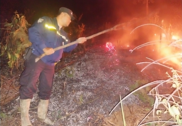 Personel Polsek SD Hole saat memadamkan api di Lahan milik warga yang dibakar di Desa Parau Sorat Sitabotabo