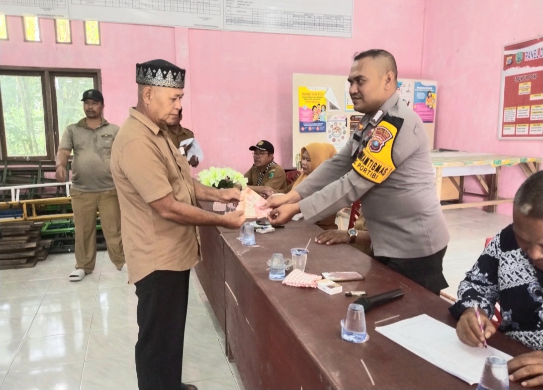 Bhabinkamtibmas Polsek Padang Bolak, Bripka Amranuddin Siregar, hadir di tengah-tengah masyarakat mengawal penyaluran BLT dari pemerintah tahun 2025
