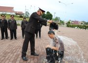 Kapolres Tapsel, AKBP Yon Edi Winara, saat menyirami air bunga ke Kompol Polman Pasaribu, selaku Plt Kasiwas yang naik pangkat dari AKP terhitung mulai 1 Oktober 2025 (TMT 01-10-2025), sebagai tradisi ungkapan rasa syukur atas dedikasi dan kinerja selama bertugas
